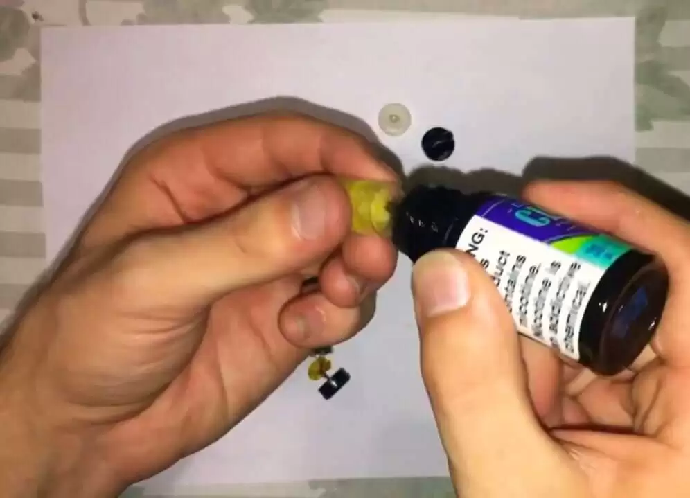 drop a few spills into the plastic container Image